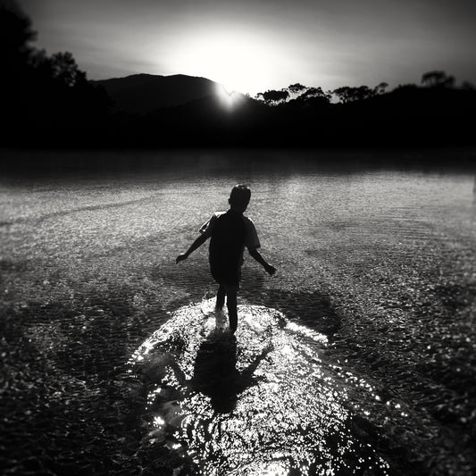 A Young Boy Dancing in the Last Light Falling on Water  - Fineart archival print, wallart